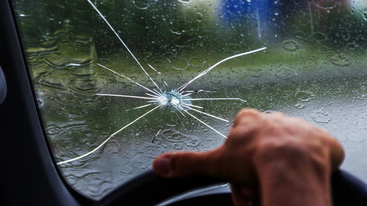 A small rock bounces off the windshield